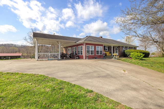 5245 US-68 W, Gravel Switch, KY 40328 - view of front of house featuring concrete driveway, covered porch, a front lawn, a chimney, and a carport