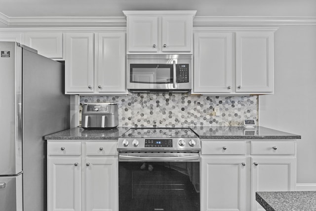 kitchen featuring stainless steel appliances, white cabinetry, and tasteful backsplash