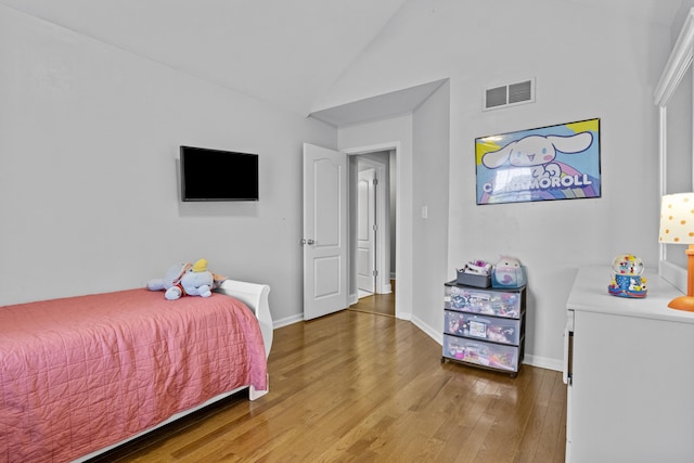 bedroom featuring wood finished floors, high vaulted ceiling, and baseboards