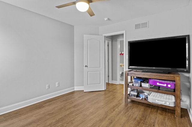 living area featuring ceiling fan, wood finished floors, and baseboards