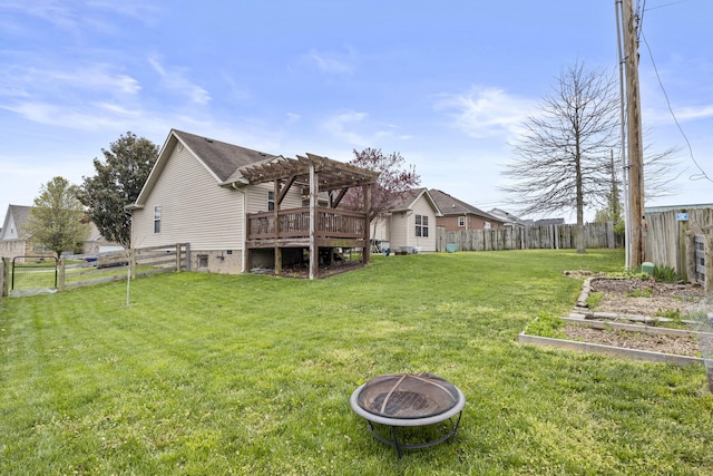 back of property featuring a pergola, an outdoor fire pit, a garden, and a deck