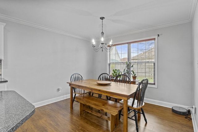 dining space with a chandelier, ornamental molding, dark wood-style flooring, and baseboards