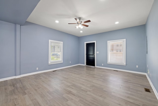 empty room with baseboards, recessed lighting, visible vents, ceiling fan, and wood finished floors