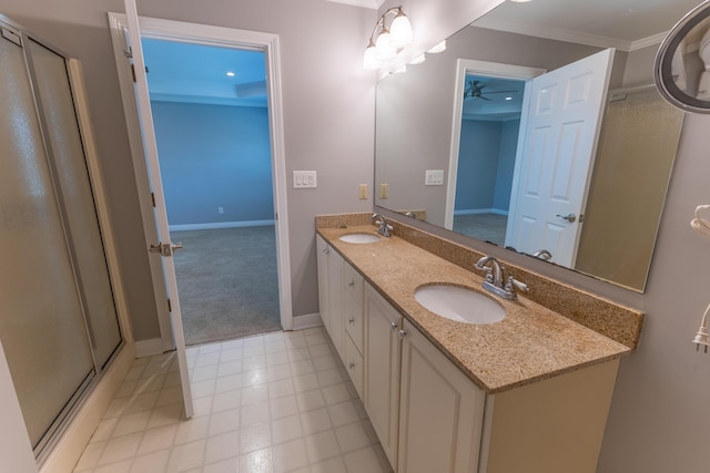 bathroom featuring a sink, ornamental molding, a ceiling fan, and double vanity