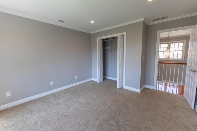 unfurnished bedroom with crown molding, visible vents, baseboards, and carpet flooring