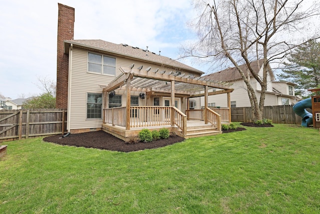 rear view of property featuring a chimney, a pergola, a fenced backyard, a deck, and a lawn