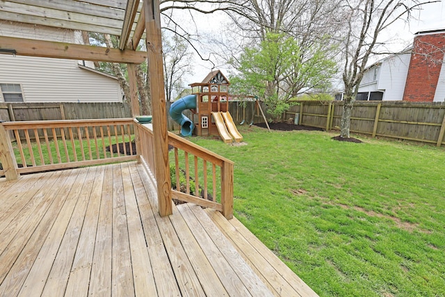 deck featuring a fenced backyard, a playground, and a lawn