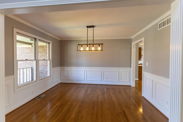 unfurnished dining area featuring dark wood-style flooring, visible vents, and a wealth of natural light