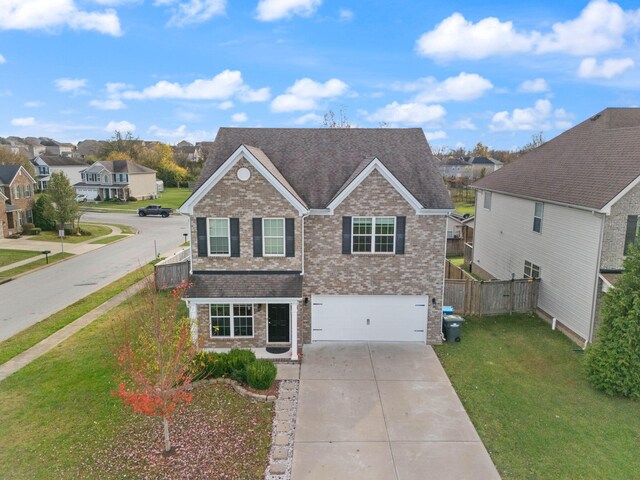 100 Barry Rd, Georgetown, KY 40324 - traditional-style home featuring a front lawn, a residential view, driveway, brick siding, and fence