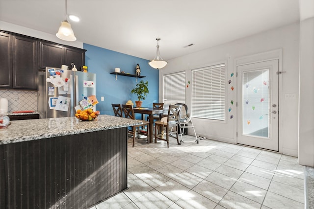 100 Barry Rd, Georgetown, KY 40324 - kitchen with light stone counters, pendant lighting, freestanding refrigerator, dark brown cabinetry, and light tile patterned flooring