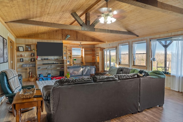 living room with vaulted ceiling with beams, plenty of natural light, and wooden ceiling