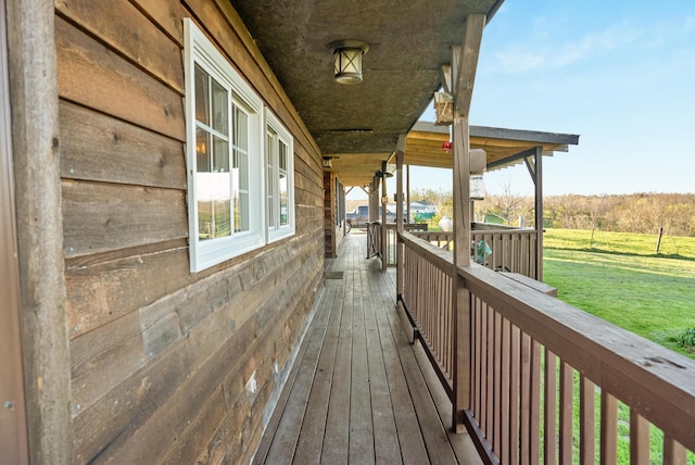 wooden terrace with a lawn
