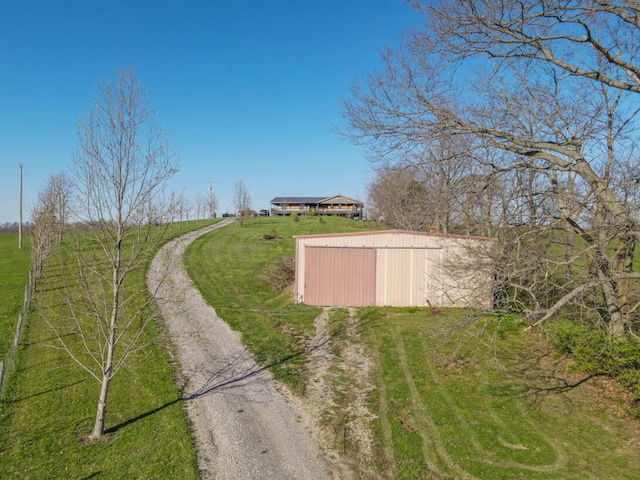 view of road featuring an outbuilding