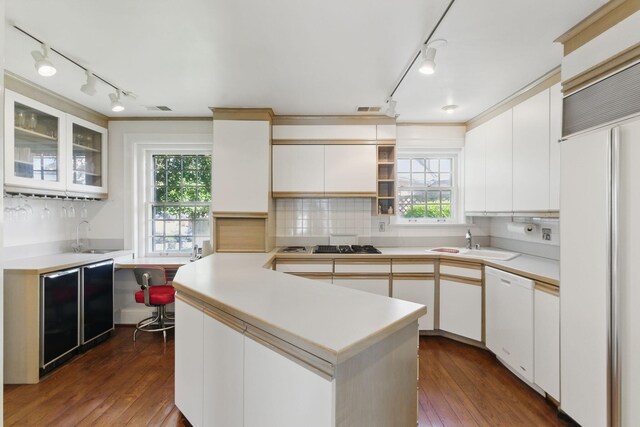 216 Ridgeway Rd, Lexington, KY 40502 - kitchen featuring paneled refrigerator, dishwasher, dark wood-style flooring, and light countertops