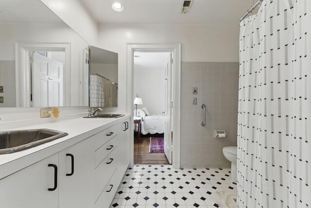 216 Ridgeway Rd, Lexington, KY 40502 - bathroom featuring a sink, visible vents, tile walls, and double vanity