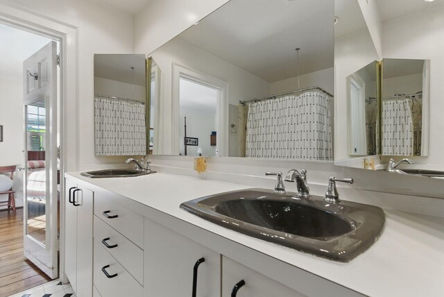 216 Ridgeway Rd, Lexington, KY 40502 - full bathroom with wood finished floors, double vanity, and a sink