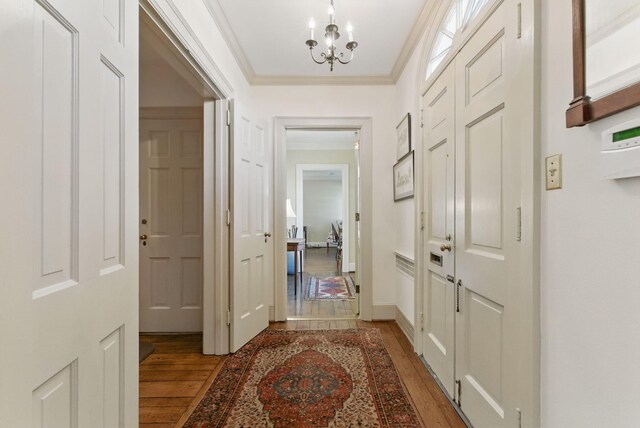 216 Ridgeway Rd, Lexington, KY 40502 - corridor with crown molding, baseboards, a notable chandelier, and light wood-style floors
