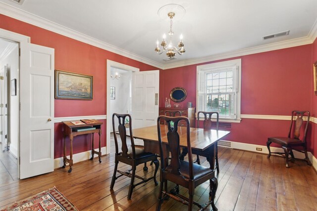 216 Ridgeway Rd, Lexington, KY 40502 - dining area featuring visible vents, baseboards, an inviting chandelier, ornamental molding, and hardwood / wood-style floors
