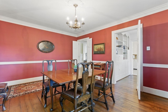 216 Ridgeway Rd, Lexington, KY 40502 - dining room featuring wood-type flooring, baseboards, and a notable chandelier