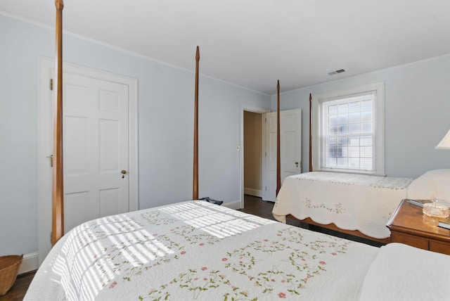 216 Ridgeway Rd, Lexington, KY 40502 - bedroom with crown molding, visible vents, baseboards, and dark wood-style floors