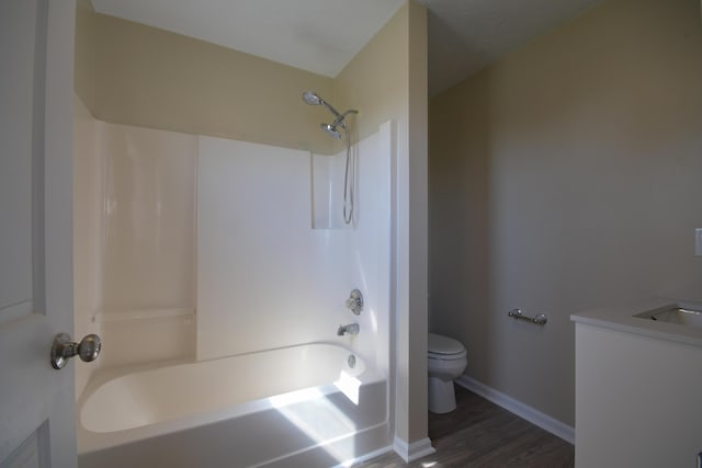 186 Main St, Sharpsburg, KY 40374 - bathroom featuring wood finished floors, shower / bathtub combination, toilet, vanity, and baseboards