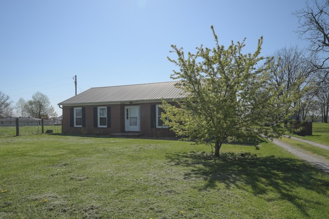 186 Main St, Sharpsburg, KY 40374 - ranch-style home with brick siding, metal roof, a front yard, and fence