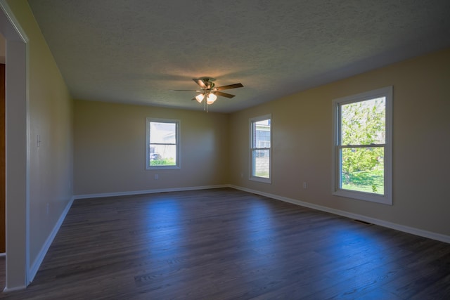 186 Main St, Sharpsburg, KY 40374 - spare room with a ceiling fan, baseboards, a textured ceiling, and dark wood-style flooring