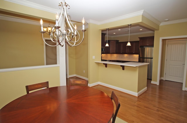 unfurnished dining area with dark wood-type flooring, ornamental molding, recessed lighting, a chandelier, and baseboards