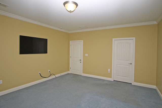 empty room featuring visible vents, baseboards, crown molding, and dark carpet