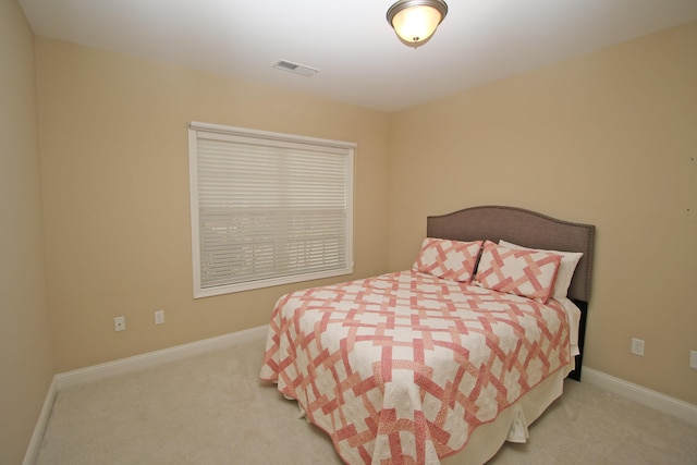 carpeted bedroom featuring visible vents and baseboards