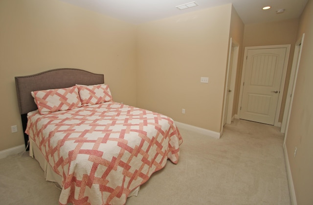 bedroom with visible vents, light colored carpet, and baseboards