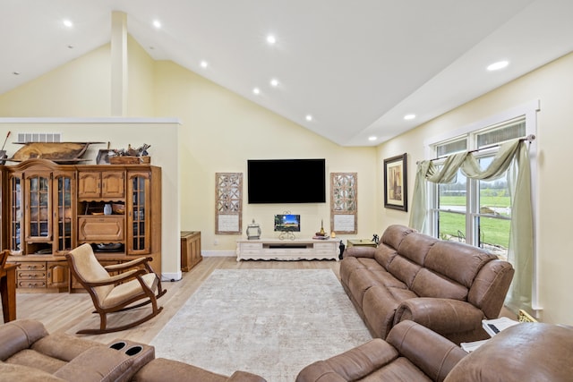 living area featuring baseboards, recessed lighting, light wood-style floors, visible vents, and high vaulted ceiling