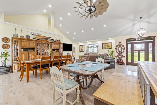 dining room with visible vents, light wood-type flooring, high vaulted ceiling, and recessed lighting