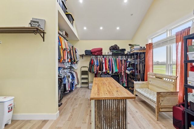 walk in closet featuring wood finished floors and vaulted ceiling