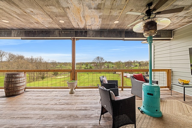 wooden terrace featuring a ceiling fan