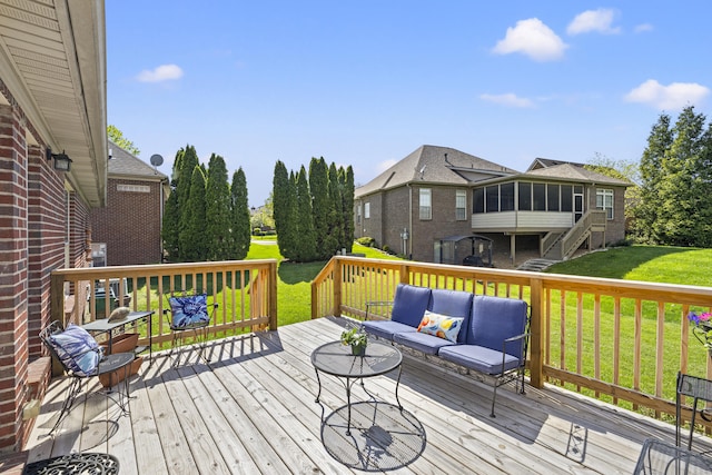 wooden terrace featuring a yard, an outdoor living space, stairs, and a sunroom