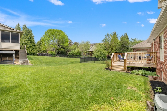 view of yard featuring fence, a deck, and stairway