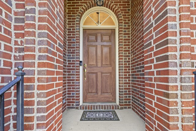 view of exterior entry with brick siding