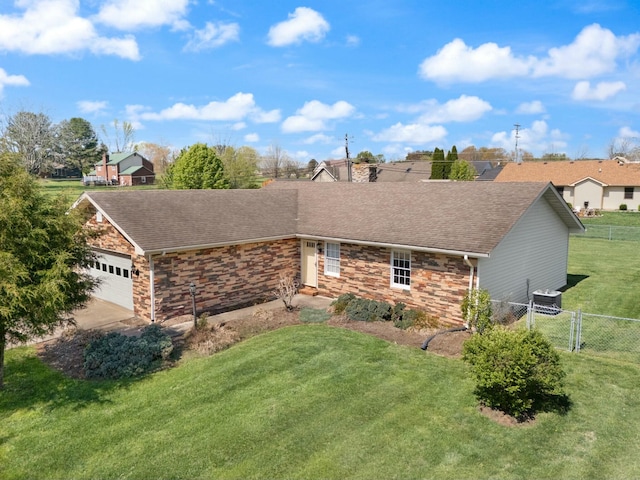 1124 Heartland Dr, Somerset, KY 42503 - exterior space featuring an attached garage, fence, stone siding, and a lawn