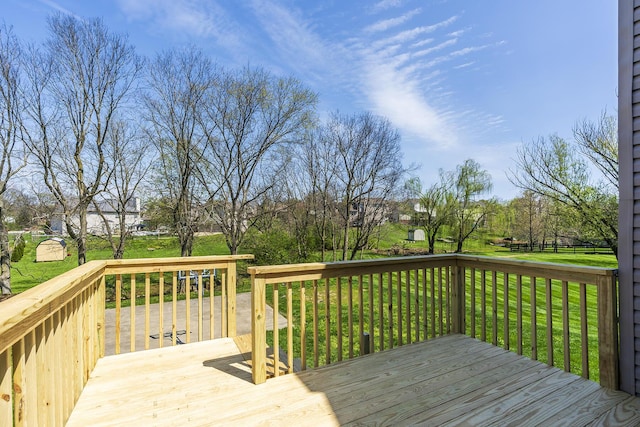 wooden terrace with a lawn