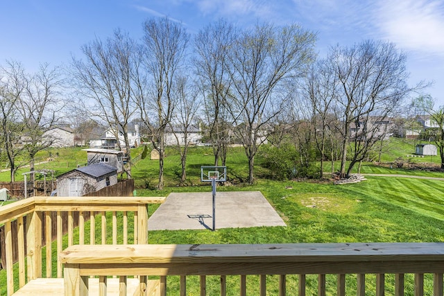 deck featuring an outbuilding, a storage shed, and a lawn