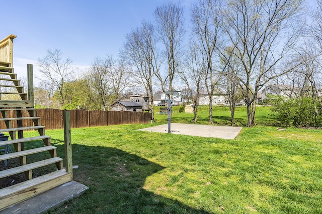 view of yard with fence and stairway