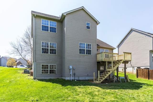 back of house featuring central AC unit, stairway, a deck, and a lawn