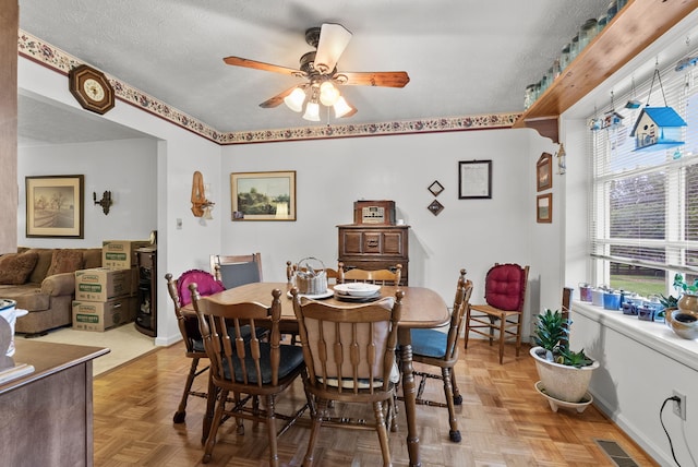 dining space with ceiling fan and visible vents