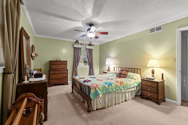 bedroom with visible vents, ornamental molding, a textured ceiling, and light carpet