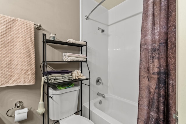 bathroom featuring shower / bath combination with curtain and toilet