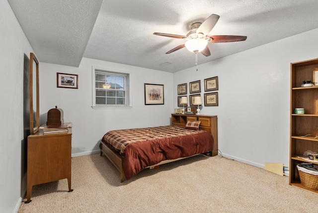 bedroom with baseboards, carpet, and a textured ceiling