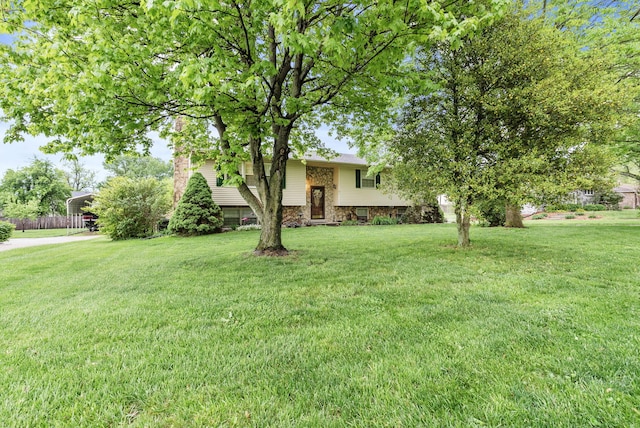view of front facade with a front yard and a carport
