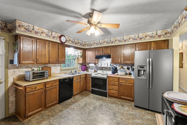 kitchen featuring electric range, a toaster, under cabinet range hood, stainless steel fridge, and black dishwasher