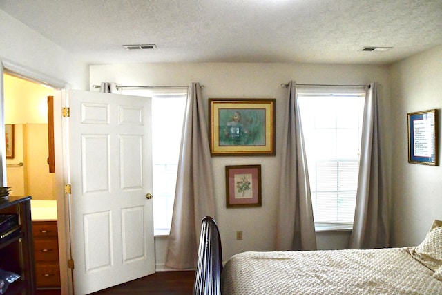 367 Old Rocky Rd, Mount Vernon, KY 40456 - bedroom featuring a textured ceiling, visible vents, and dark wood-type flooring
